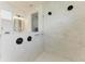 Shower featuring neutral tiling and black shower fixtures in modern bathroom at 5428 Title Row Dr, Bradenton, FL 34210