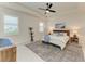 Bright bedroom with a ceiling fan, shutters on the windows, and modern rustic wood furniture at 5428 Title Row Dr, Bradenton, FL 34210