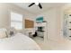 Bedroom with daybed, built in shelving, a desk with rolling chair and shutters at 5428 Title Row Dr, Bradenton, FL 34210