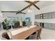 Open dining and living area with exposed wood beams and view of the outdoor living area at 5428 Title Row Dr, Bradenton, FL 34210