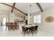 Well-lit dining area features exposed beams, marble floors, and a view of the kitchen at 5428 Title Row Dr, Bradenton, FL 34210