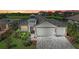 Attractive home with a gray roof, three-car garage, and landscaped front yard at 5428 Title Row Dr, Bradenton, FL 34210