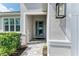 Inviting front door with modern design and tiled entrance, surrounded by green shrubs at 5428 Title Row Dr, Bradenton, FL 34210
