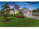 Charming home featuring well-manicured lawn, lush landscaping, and a three-car garage at 5428 Title Row Dr, Bradenton, FL 34210