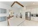 Open-concept kitchen with a large island, white cabinets, stainless steel appliances, and wood beams at 5428 Title Row Dr, Bradenton, FL 34210