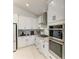 Well-lit kitchen with white cabinets, stainless steel appliances, and a stylish backsplash at 5428 Title Row Dr, Bradenton, FL 34210