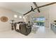 Open living room with vaulted ceilings, exposed beams, and a view of the outdoor patio at 5428 Title Row Dr, Bradenton, FL 34210