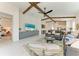 Open-concept living area boasts exposed beams, vaulted ceilings, and a view of the bedroom at 5428 Title Row Dr, Bradenton, FL 34210