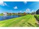 Scenic view of a tranquil pond surrounded by lush landscaping and luxurious homes at 5428 Title Row Dr, Bradenton, FL 34210