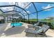 Screened-in pool area featuring lounge chairs overlooking a beautiful view at 5428 Title Row Dr, Bradenton, FL 34210