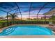 A private swimming pool set against a backdrop of a beautiful sunset and landscaping at 5428 Title Row Dr, Bradenton, FL 34210