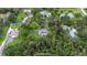 Aerial view showing the home with a large lot surrounded by mature trees offering privacy at 5430 Richardson Rd, Sarasota, FL 34232
