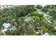Aerial view highlighting a tree-lined backyard, the pool, and property lines at 5430 Richardson Rd, Sarasota, FL 34232