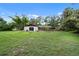 Lush backyard with green grass and mature trees offering privacy at 5430 Richardson Rd, Sarasota, FL 34232