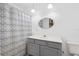 Bathroom with gray vanity, mirror, and shower with curtain at 5430 Richardson Rd, Sarasota, FL 34232