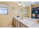 Bathroom with long vanity, large mirror and decorative shower curtain at 5430 Richardson Rd, Sarasota, FL 34232