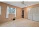 Cozy bedroom includes a ceiling fan, window view, and closet providing storage and natural light at 5430 Richardson Rd, Sarasota, FL 34232