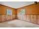 Bedroom featuring wall paneling and two windows at 5430 Richardson Rd, Sarasota, FL 34232