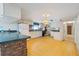 Spacious kitchen features white cabinetry, appliances, and ample counter space and flows into living spaces at 5430 Richardson Rd, Sarasota, FL 34232
