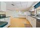 Bright kitchen features ample counter space, white cabinets, and a view into an adjacent living area at 5430 Richardson Rd, Sarasota, FL 34232
