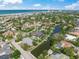 Aerial view of gorgeous single-story home with boat dock access, surrounded by canals and lush landscaping at 5569 Cape Leyte Dr, Sarasota, FL 34242