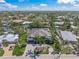 Aerial view of beautiful single-story home with spacious brick driveway, surrounded by lush landscaping and a tranquil canal at 5569 Cape Leyte Dr, Sarasota, FL 34242
