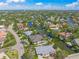 Aerial view of lovely single-story home with boat dock access, surrounded by canals and lush landscaping at 5569 Cape Leyte Dr, Sarasota, FL 34242