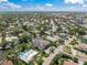 Beautiful aerial view of a waterfront home surrounded by lush landscaping, canals, and nearby roads at 5569 Cape Leyte Dr, Sarasota, FL 34242