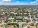 Aerial view of stunning single-story home with boat dock access, surrounded by canals and tropical landscaping at 5569 Cape Leyte Dr, Sarasota, FL 34242