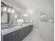 Elegant bathroom features a double sink vanity, large mirror, and glass-enclosed shower at 5569 Cape Leyte Dr, Sarasota, FL 34242