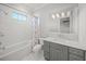 Clean, modern bathroom features a shower-tub combo, neutral tile, and plenty of counter space at 5569 Cape Leyte Dr, Sarasota, FL 34242