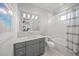 Well-lit bathroom featuring a sleek vanity with marble countertops and a shower-tub combo at 5569 Cape Leyte Dr, Sarasota, FL 34242