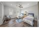 Bright, neutral bedroom features two twin beds, an accent chair, and hardwood floors at 5569 Cape Leyte Dr, Sarasota, FL 34242