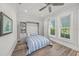 Comfortable bedroom showcasing a built-in Murphy bed, storage cabinets and natural light from the two windows at 5569 Cape Leyte Dr, Sarasota, FL 34242