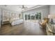 Bright bedroom with hardwood floors, a ceiling fan, and direct access to the outdoors at 5569 Cape Leyte Dr, Sarasota, FL 34242