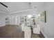 Bright dining room features a chandelier, hardwood floors, and views of the outdoors at 5569 Cape Leyte Dr, Sarasota, FL 34242