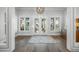 Bright foyer with hardwood floors, a decorative rug, and a view of the outdoors at 5569 Cape Leyte Dr, Sarasota, FL 34242