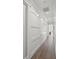 Hallway features dark hardwood floors, sliding barn doors, and neutral colored walls and trim at 5569 Cape Leyte Dr, Sarasota, FL 34242
