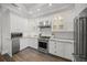 Bright kitchen with stainless steel appliances, white cabinetry, granite countertops and hardwood floors at 5569 Cape Leyte Dr, Sarasota, FL 34242