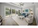 Bright living room with a ceiling fan, hardwood floors, and direct access to the pool at 5569 Cape Leyte Dr, Sarasota, FL 34242