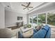Cozy living room with hardwood floors, a ceiling fan, and direct access to the pool at 5569 Cape Leyte Dr, Sarasota, FL 34242