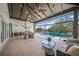 An outdoor living area boasting a summer kitchen, elegant seating, and a sparkling swimming pool at 5569 Cape Leyte Dr, Sarasota, FL 34242