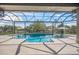 Sparkling swimming pool with spa surrounded by a spacious patio and screened enclosure, creating a private oasis at 5569 Cape Leyte Dr, Sarasota, FL 34242