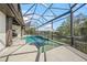 A sparkling pool next to a lake surrounded by a screened enclosure offering both relaxation and scenic waterfront views at 5569 Cape Leyte Dr, Sarasota, FL 34242