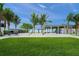Inviting public space with lush green lawn, palm trees, and open-air structures near the beach at 5569 Cape Leyte Dr, Sarasota, FL 34242