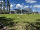 Spacious backyard with well-maintained lawn and screened patio at 620 Camellia Ave, Ellenton, FL 34222