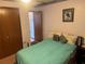 Cozy bedroom with a comfortable bed, closet, and neutral color scheme, creating a relaxing atmosphere at 620 Camellia Ave, Ellenton, FL 34222
