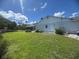 Exterior view of the home, showcasing the well-manicured lawn and backyard at 620 Camellia Ave, Ellenton, FL 34222