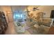 Bright and open living room with tile flooring, comfortable seating, and abundant natural light at 620 Camellia Ave, Ellenton, FL 34222