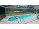 Sparkling pool in screened lanai, turtle float, and lush backyard at 620 Camellia Ave, Ellenton, FL 34222